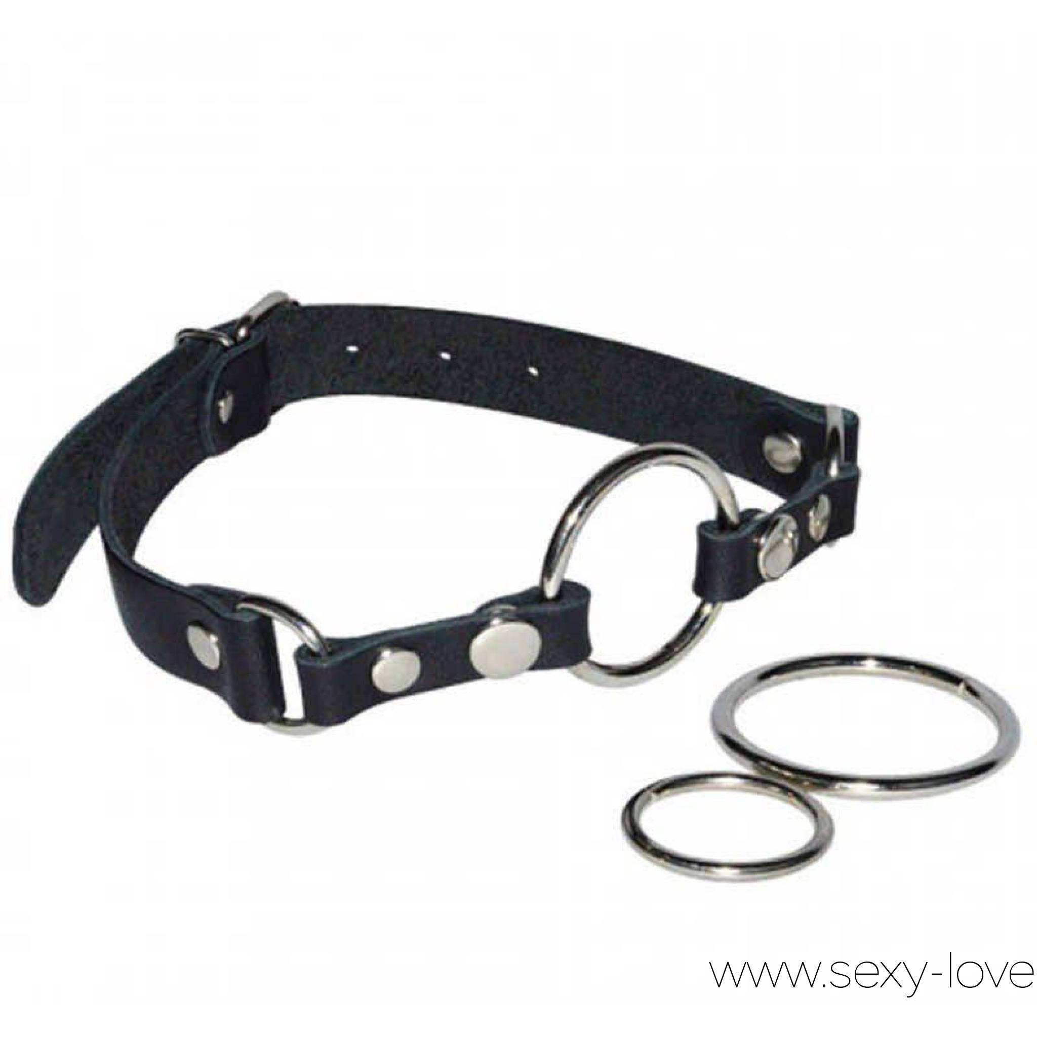 Кляп-кольцо на ремешке с тремя сменными колечками на заклепках, 
	Хорошо знакомый, классический кляп с кольцом-расширителем. Колечко приоткрывает ротик, открывая беспрепятственный доступ для члена, пальцев или интимных аксессуаров – все зависит лишь от Вашей собственной фантазии.

	 

	В комплект входят целых три сменных кольца из серебристой стали с никелевым покрытием, которые можно менять в зависимости от индивидуальных предпочтений. Для фиксации на голове используется черный кожаный ремешок. Пряжка позволяет легко настроить аксессуар по размеру. Соединения усилены металлическими клепками.

	 

	Диаметры колец: 3.8 см, 4.4 см, 5.9 см.
